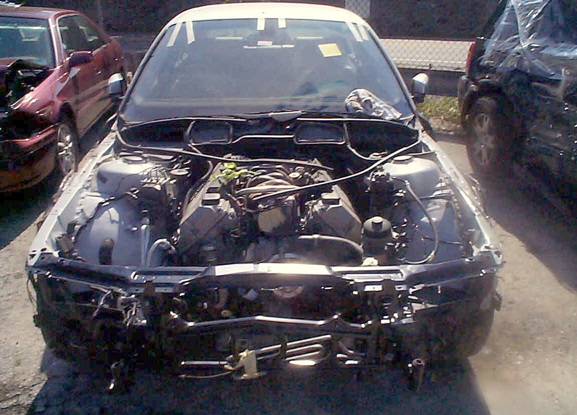 A BMW in our lot with its bumper, lights and grille removed during teardown