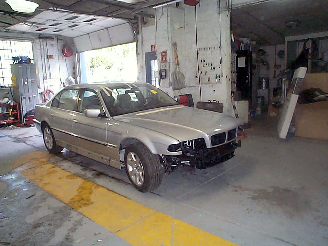 A silver BMW sedan in one of our repair bays, partway through reassembly